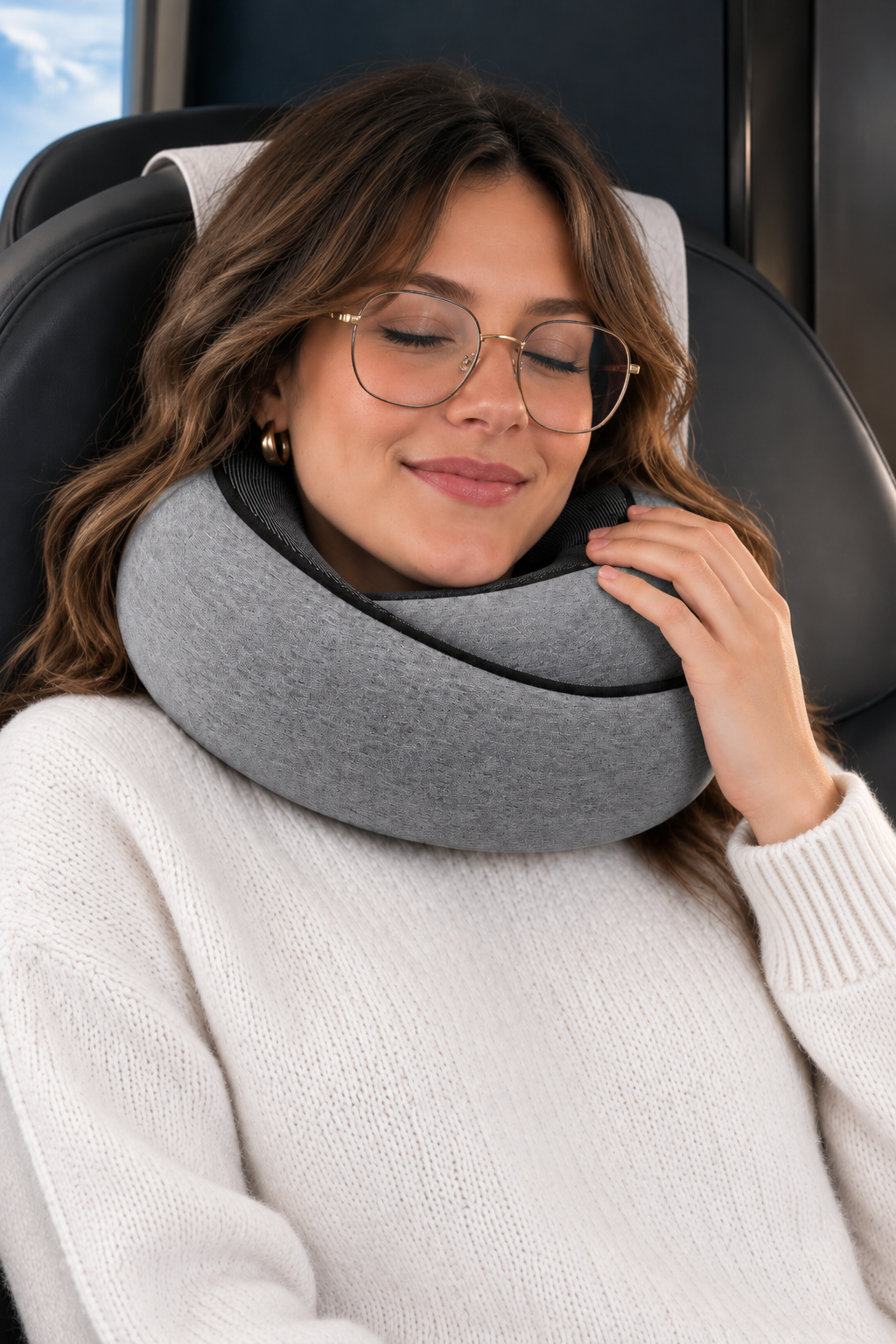A traveler asleep on a plane with the 360° travel pillow